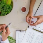 Healthcare professional discussing healthy eating and wellness at a Family Primary Care Clinic in Jacksonville with fresh fruits and vegetables.