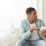 A couple reviewing information on a laptop together, illustrating the importance of learning about STD screening, understanding testing options, and taking informed steps toward sexual health.