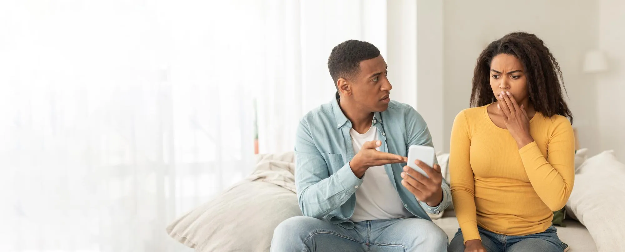 A couple reviewing information on a laptop together, illustrating the importance of learning about STD screening, understanding testing options, and taking informed steps toward sexual health.