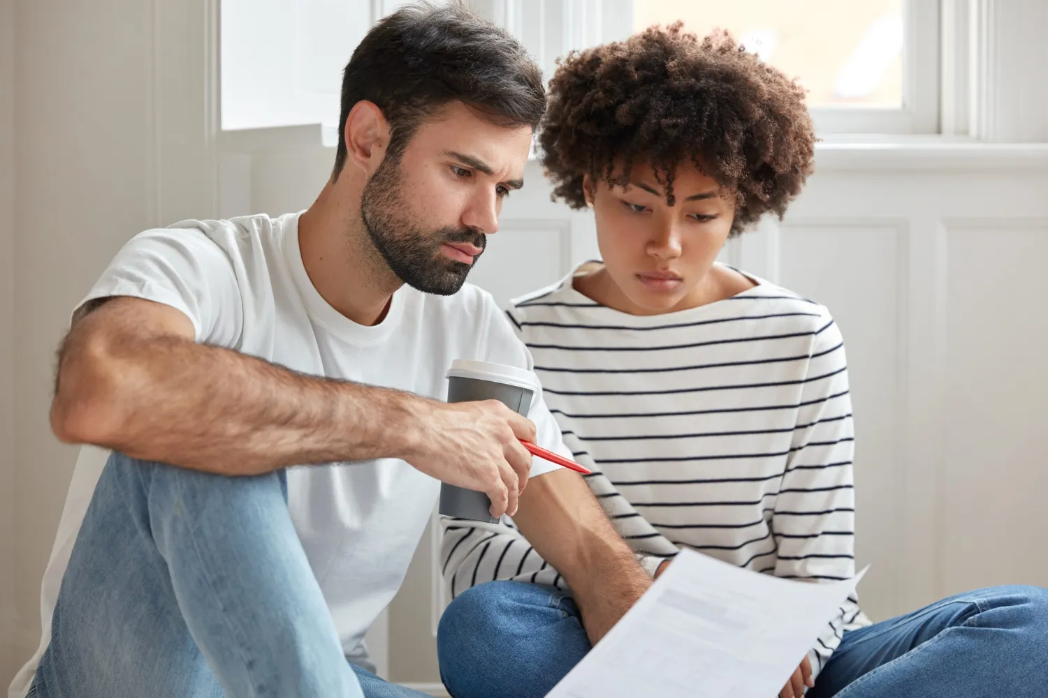 Parent and teenager discussing sexual health information before visiting an STD testing center.