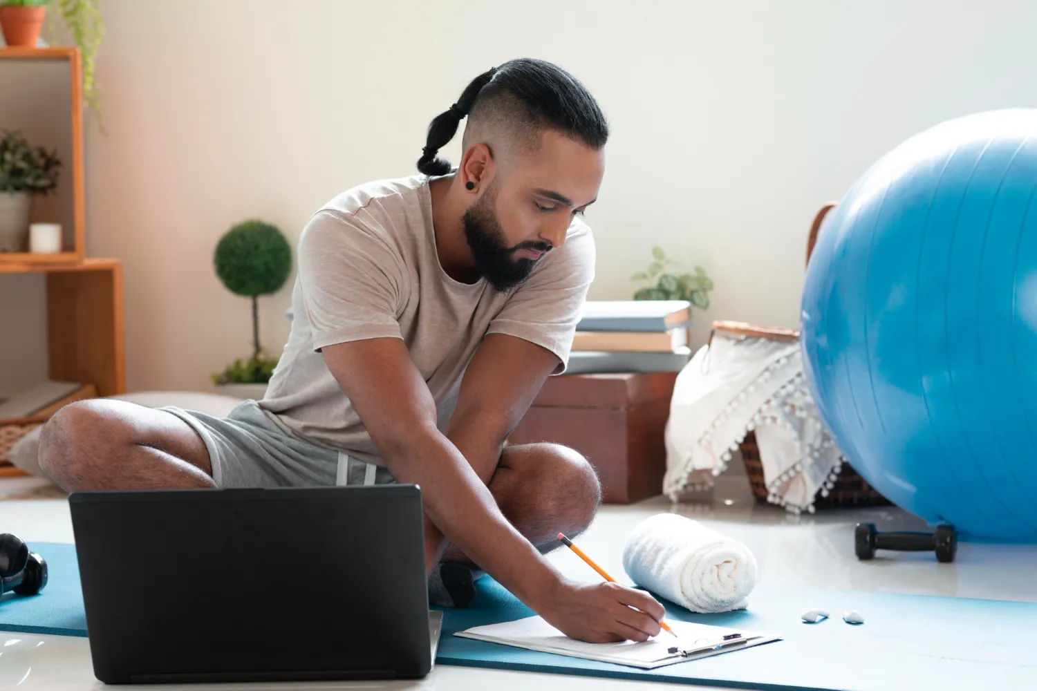 Individual completing a health assessment during a virtual wellness physical, preparing for a preventive care visit with exercise equipment nearby, highlighting comprehensive wellness services in Jacksonville.