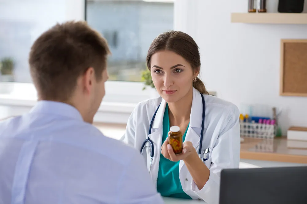 Jacksonville primary care doctor explaining prescription medication and treatment plans to a patient during a routine primary care clinic visit.