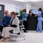 Primary care clinic in Jacksonville with patients waiting and staff assisting at reception for walk-in medical services