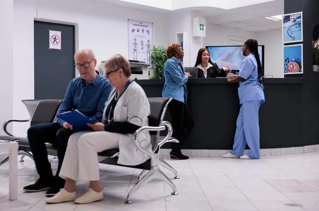 Primary care clinic in Jacksonville with patients waiting and staff assisting at reception for walk-in medical services