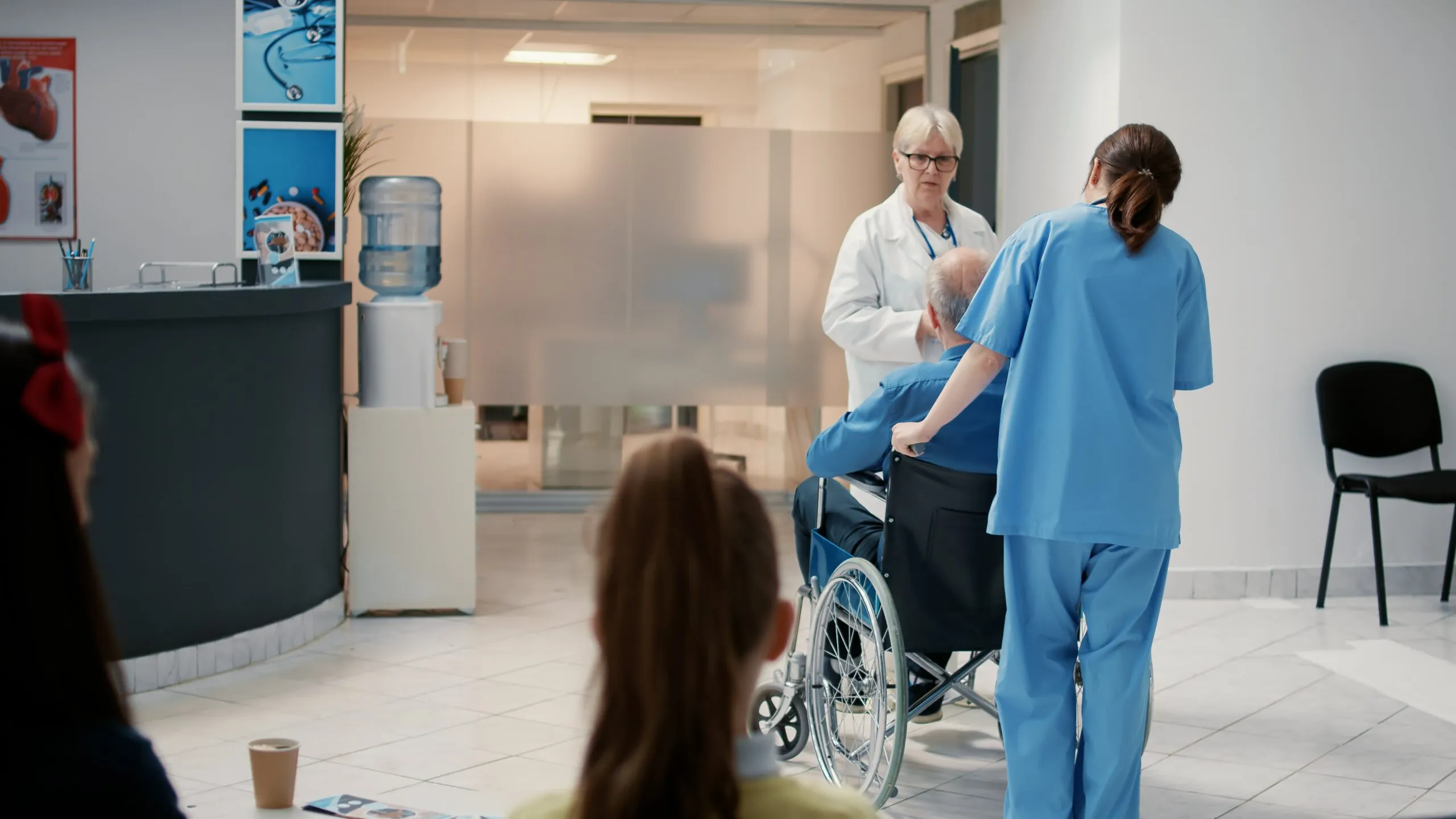 Healthcare staff assisting patient in wheelchair at walk in clinic Jacksonville FL providing urgent care and patient care services