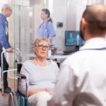 Primary care doctor in Jacksonville providing personalized care to senior patient during clinic visit