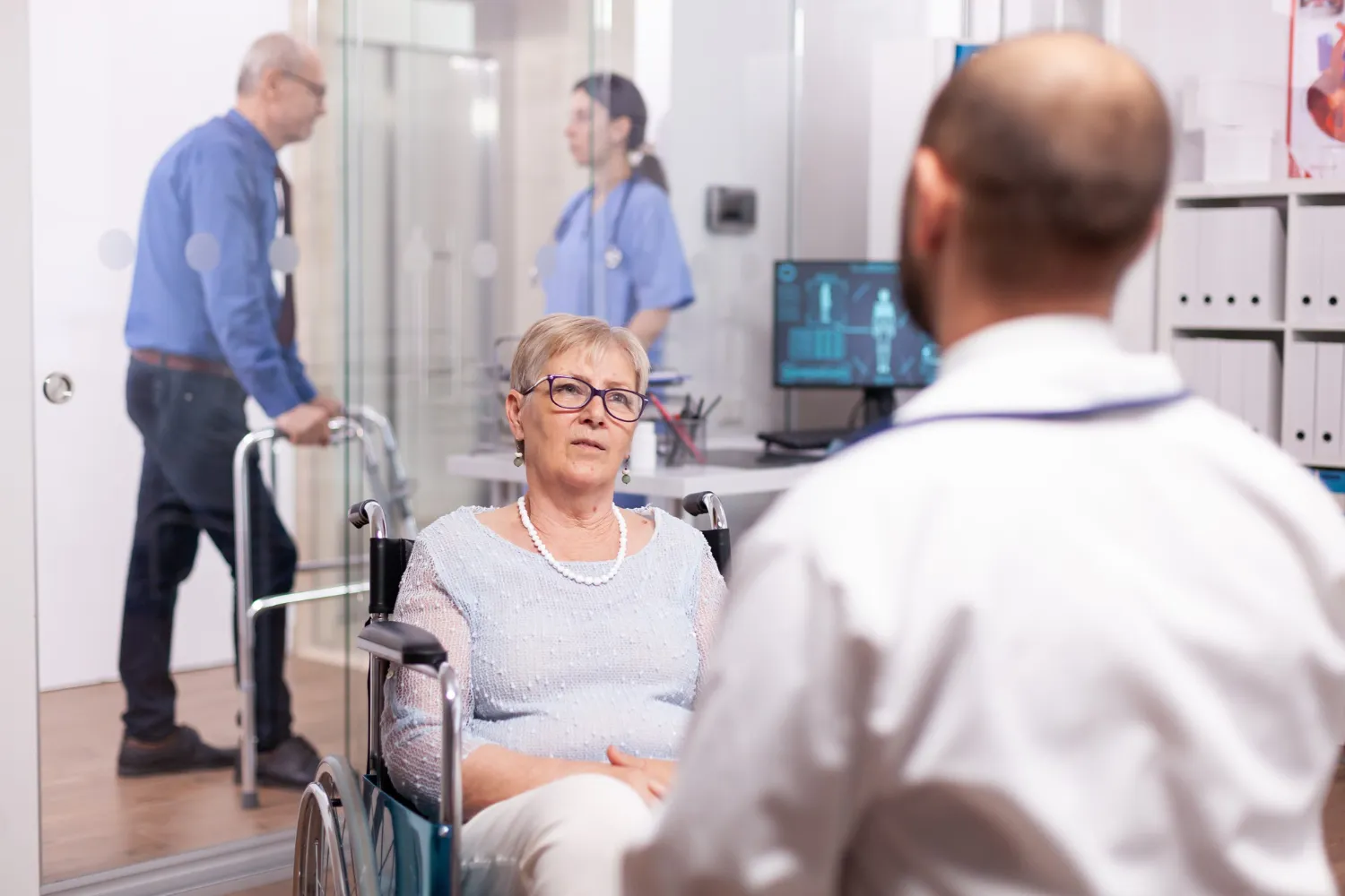 Primary care doctor in Jacksonville providing personalized care to senior patient during clinic visit