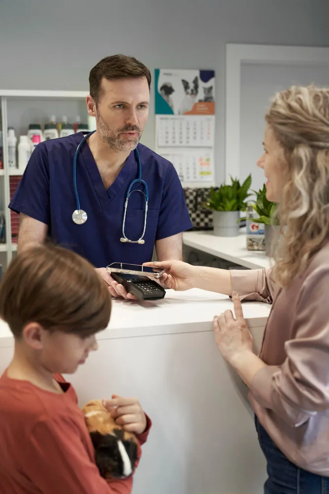 Primary care physician consulting with mother and child during routine visit at a primary care clinic