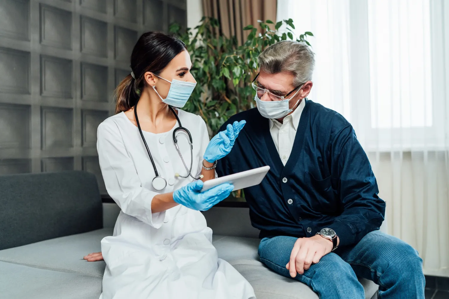 Healthcare provider consulting with a patient using a tablet, highlighting professional care and services like IV hydration therapy in Jacksonville FL and vitamin infusion treatments