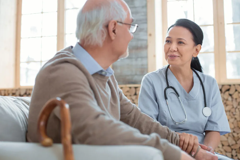 Compassionate geriatric physician providing personalized care and consultation for elderly patient at home visit