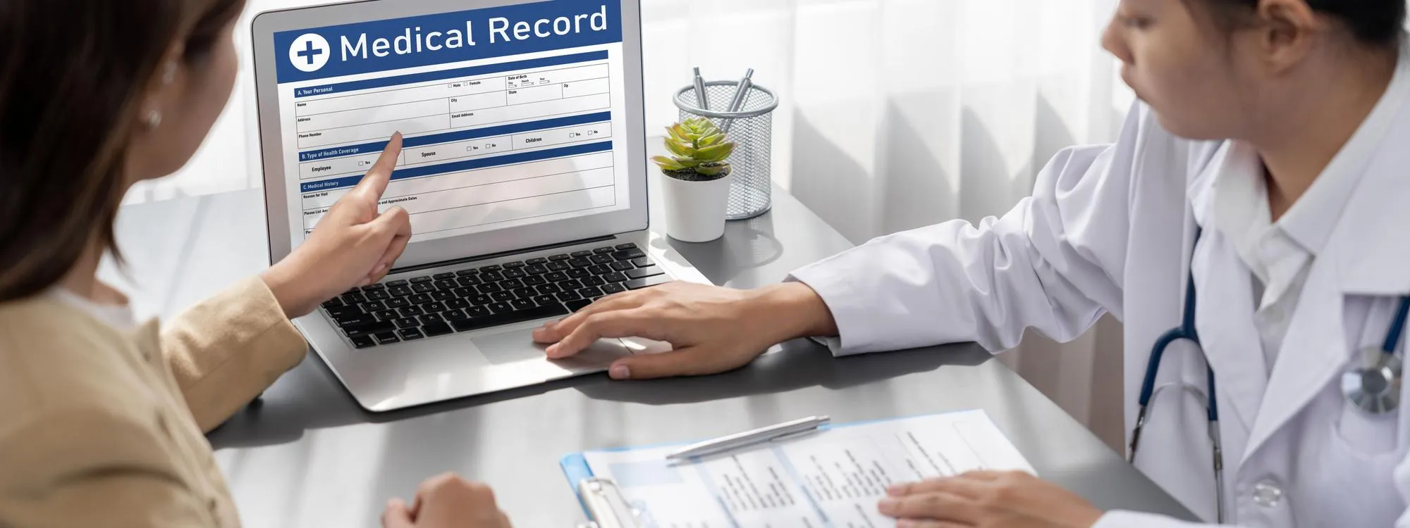 Doctor reviewing digital medical records with a patient, showcasing personalized care, preventive services, and support from geriatric doctors Jacksonville FL within a modern internal medicine clinic