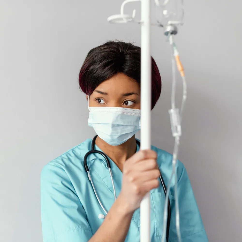 Nurse holding IV drip stand during IV infusion therapy vitamins session at IV clinic in Jacksonville FL providing professional IV hydration therapy