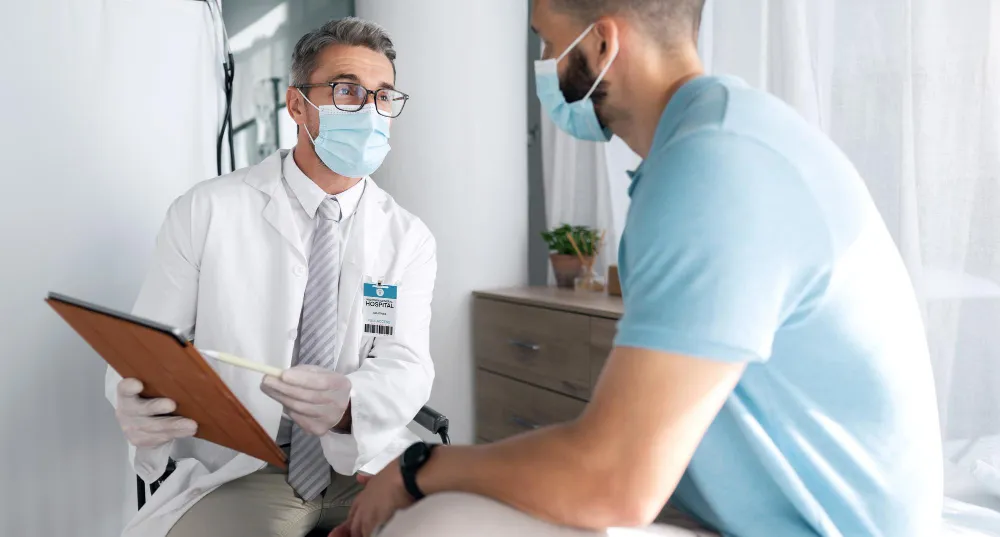 Men’s health doctor consulting patient during men’s health checkup at Jacksonville men’s clinic in Florida
