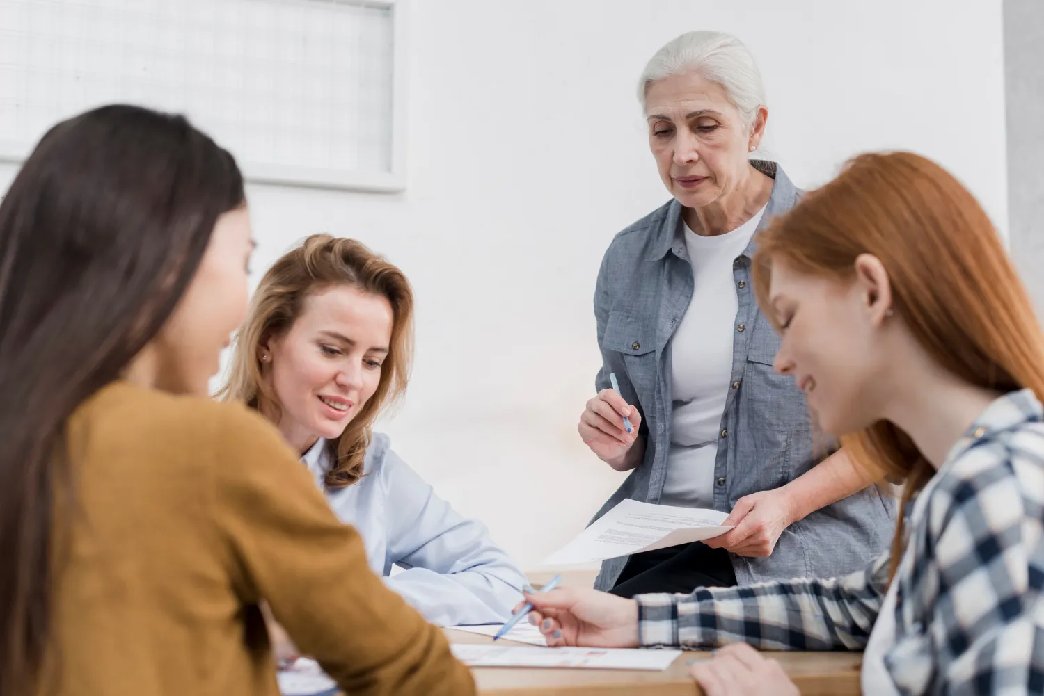 Geriatric doctor in Jacksonville FL reviewing medical documents with patients at a family medical clinic during initial consultation