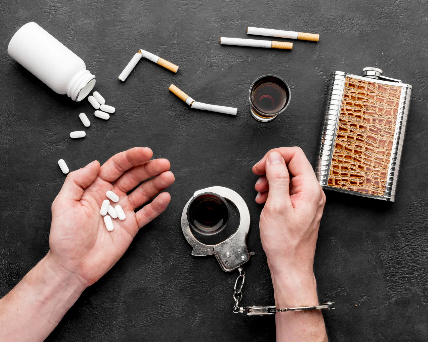 Concept of addiction recovery showing alcohol, cigarettes, and pills with handcuffs representing detox and substance abuse treatment in Jacksonville Florida