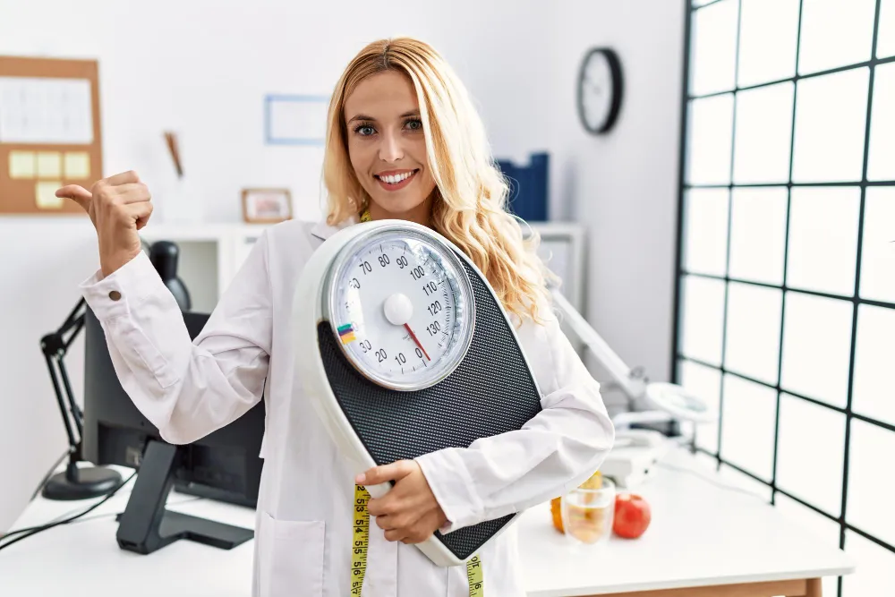 Healthcare professional promoting weight management with scale and measurement tools at a Jacksonville weight loss center
