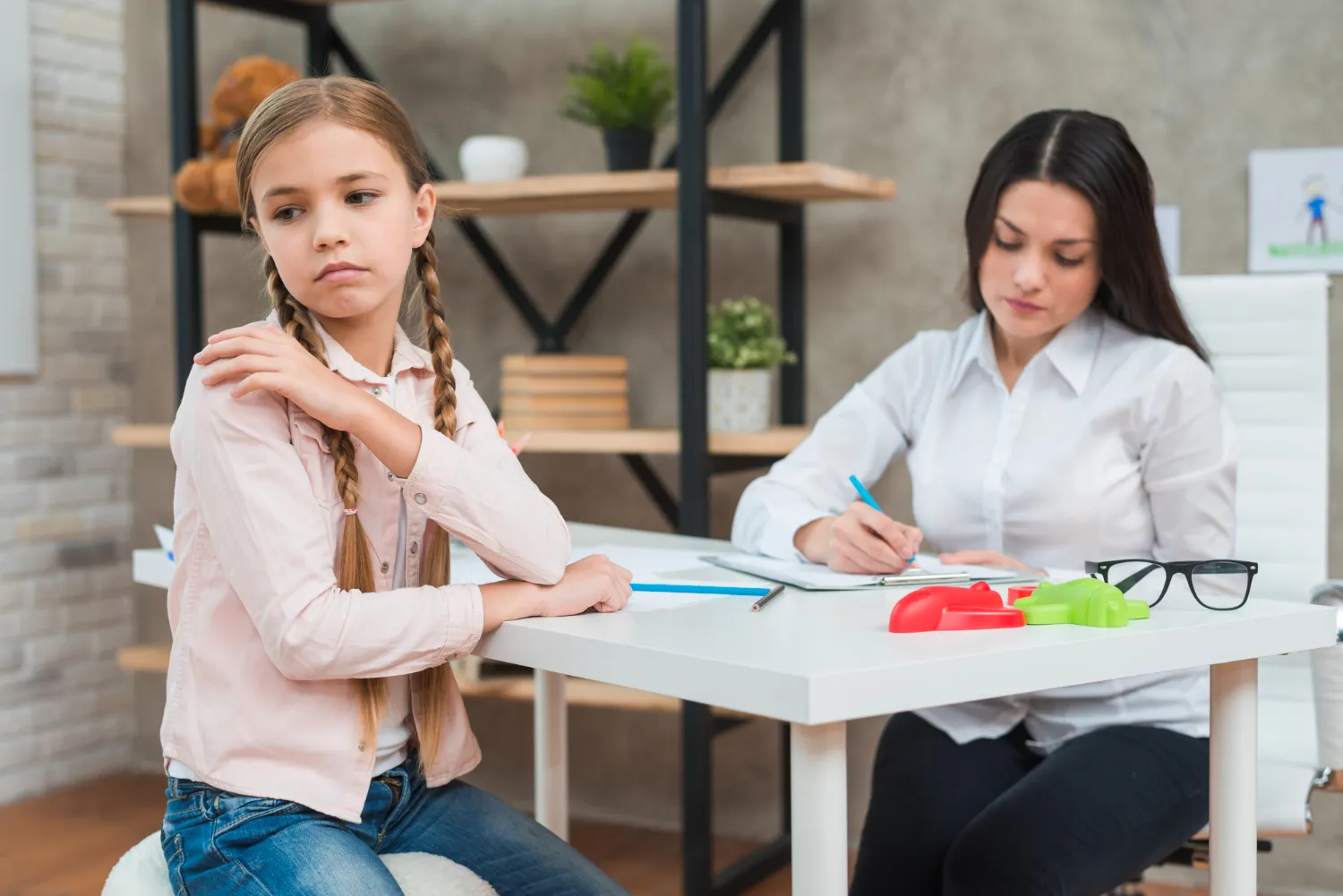 Child attending therapy session with specialist for psychosocial support and psychiatric counseling in Jacksonville