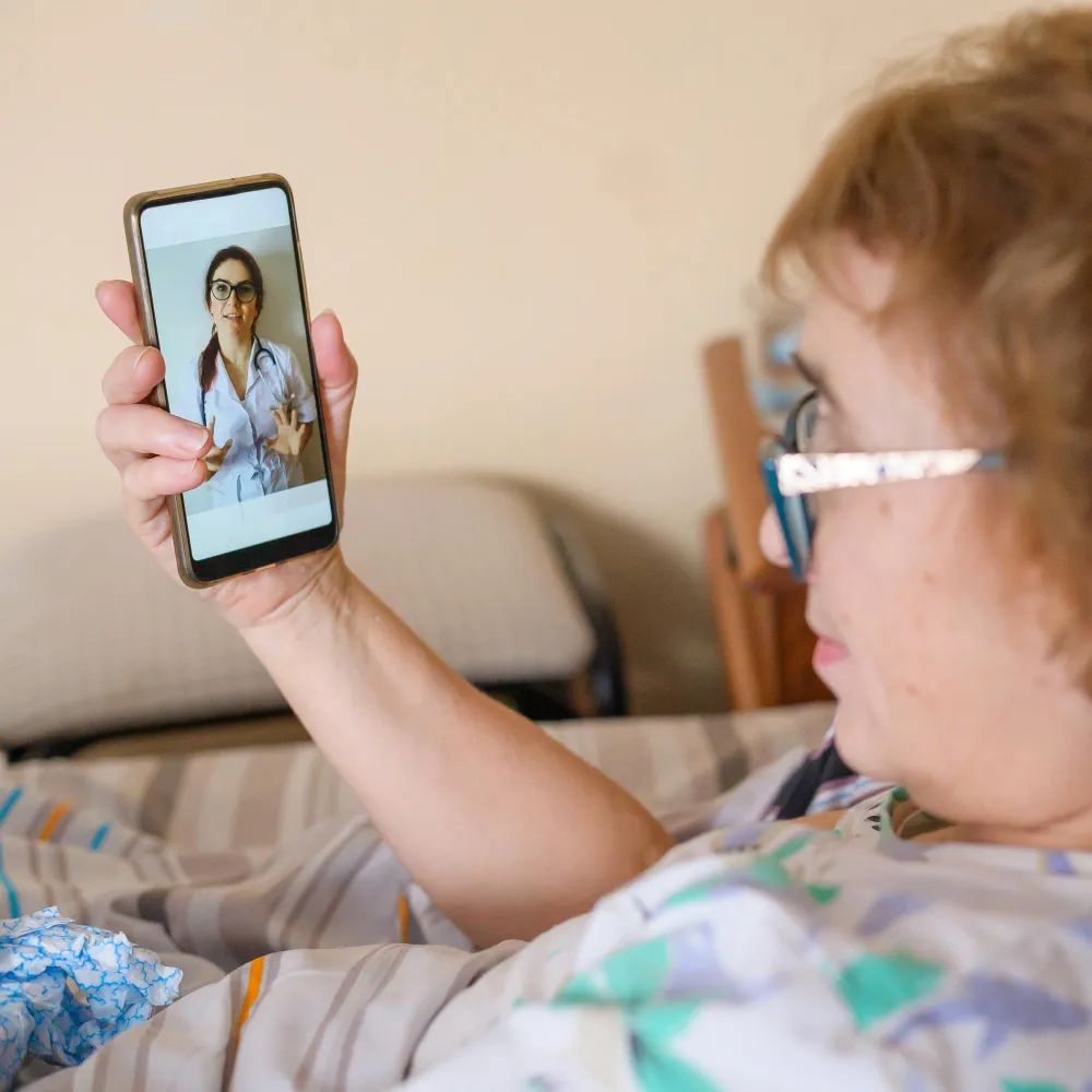 Patient attending a telehealth session on a smartphone, showcasing flexible and remote care through a trusted digital doctor visit experience
