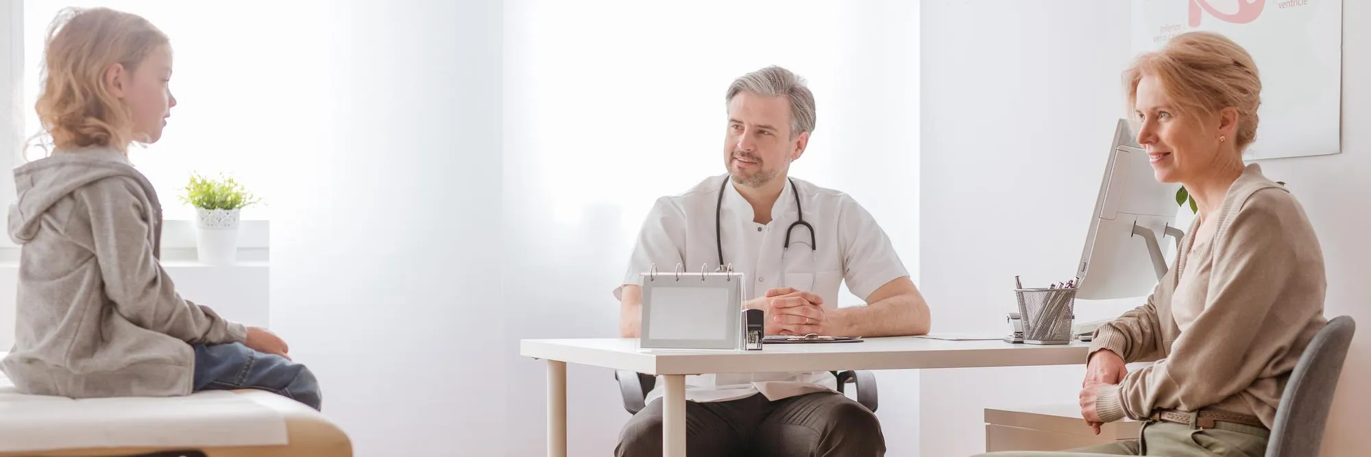 Internist in Jacksonville consulting with a child and parent during a routine medical visit, highlighting comprehensive family healthcare, preventive care, and personalized treatment for all ages.