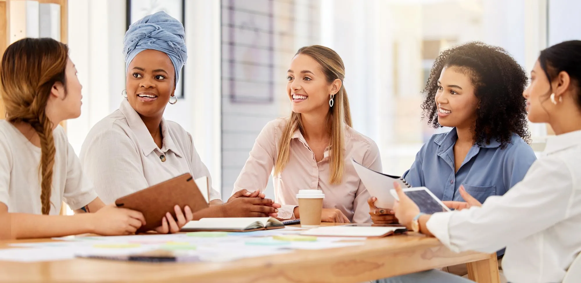 Group of women participating in a supportive wellness discussion, representing women's primary care focused on preventive health, education, and personalized care.