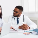 Primary Care Doctors in Jacksonville collaborating with healthcare professionals to review patient records and develop personalized treatment plans for comprehensive primary care services.