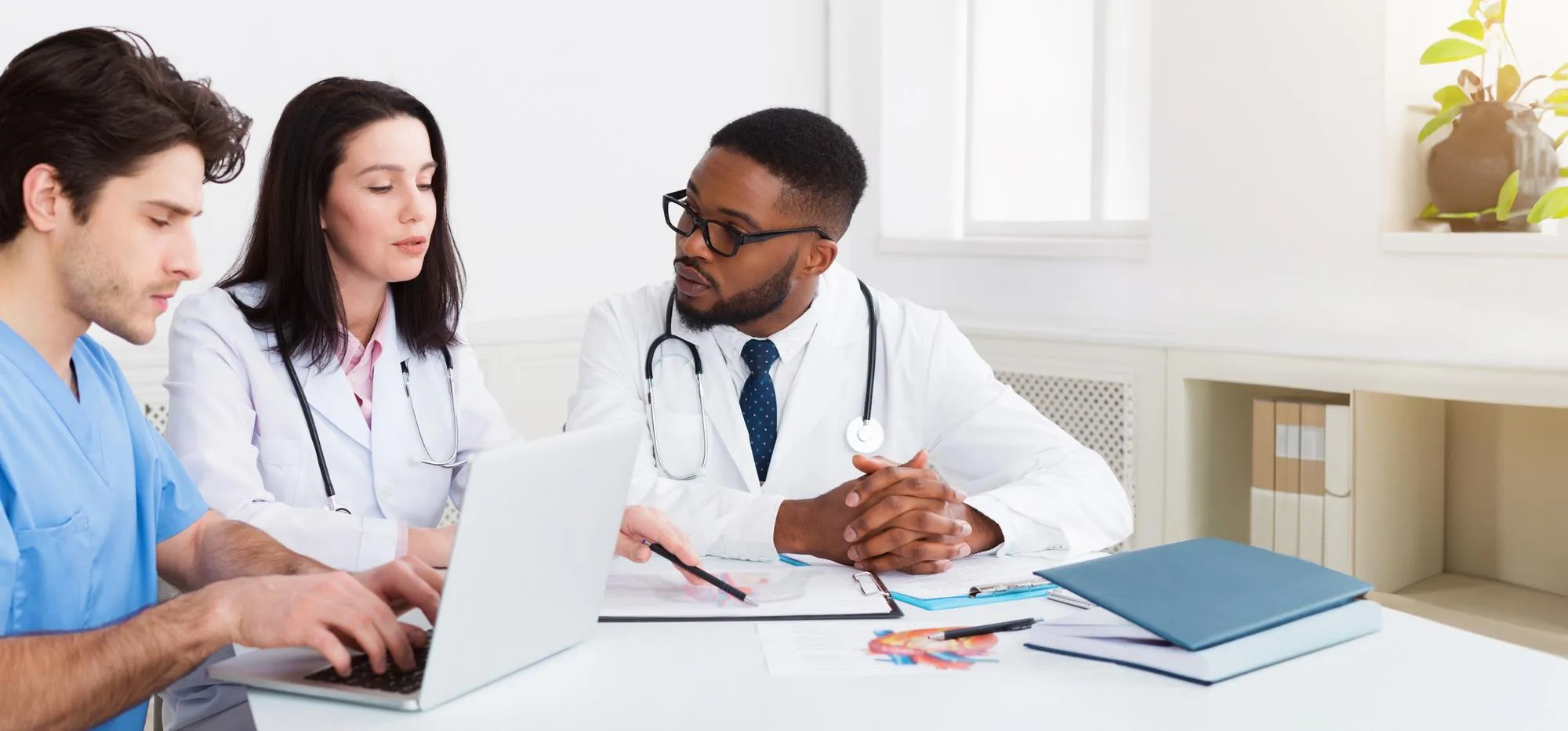 Primary Care Doctors in Jacksonville collaborating with healthcare professionals to review patient records and develop personalized treatment plans for comprehensive primary care services.