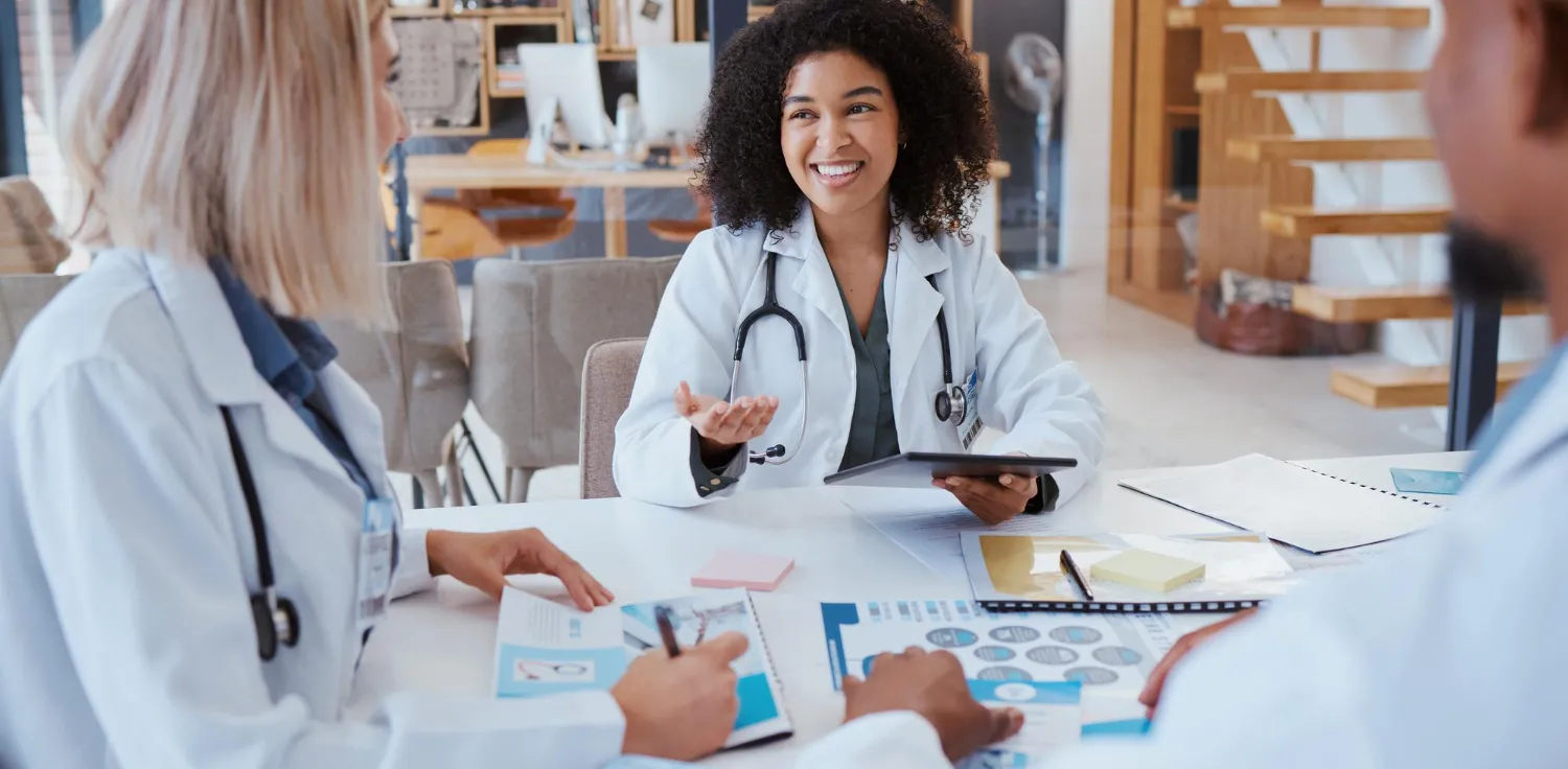 Women's primary care providers meeting to discuss patient care plans and preventive health strategies, highlighting coordinated care at a women's health clinic in Jacksonville, FL.