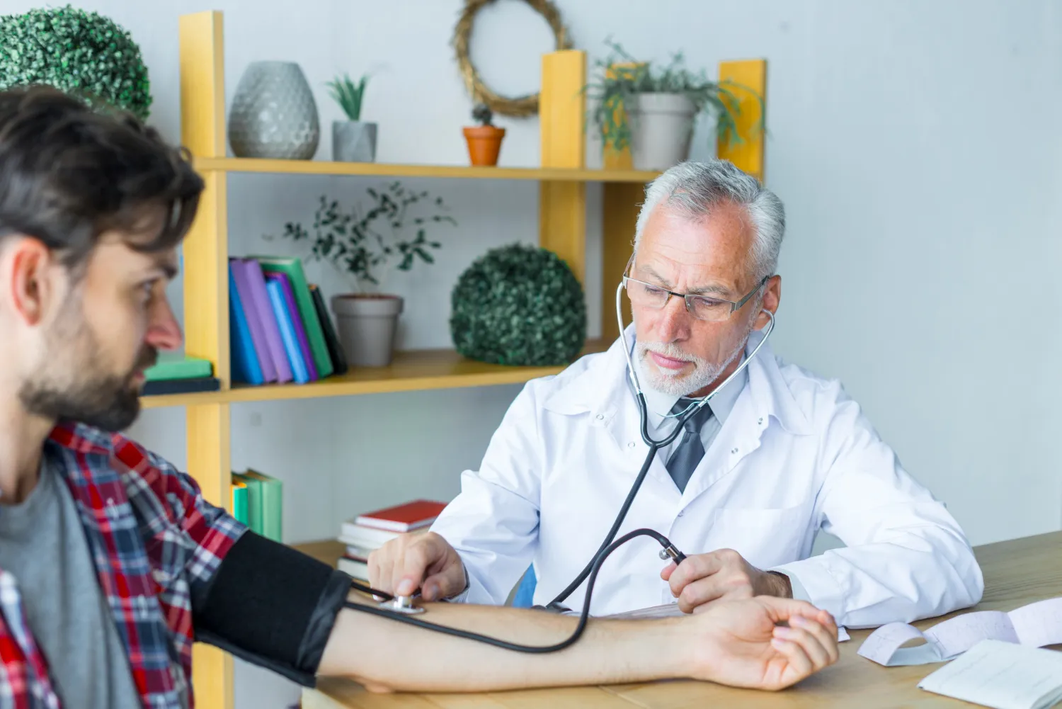 Physician in Jacksonville checking a patient's blood pressure during a routine primary care visit, supporting preventive healthcare, chronic disease management, and overall wellness.