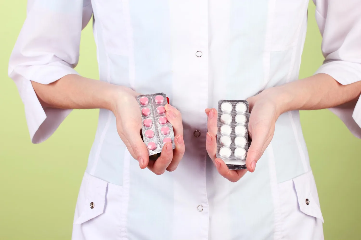 Healthcare professional holding tirzepatide and semaglutide medication packages, representing a comparison of weight loss injections