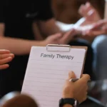 Family therapy session with a therapist supporting family communication.