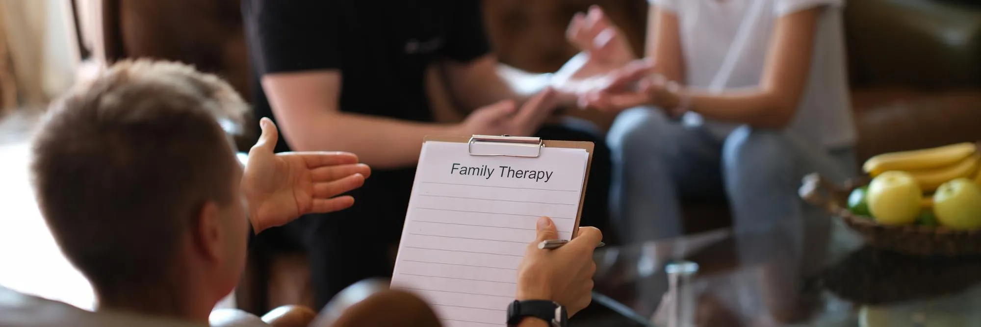 Family therapy session with a therapist supporting family communication.