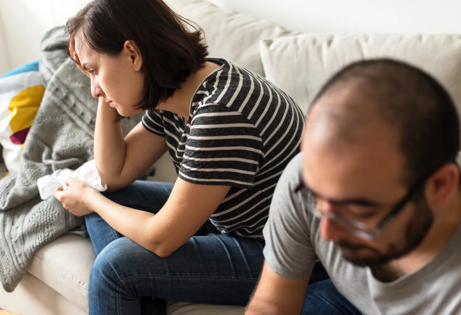 Couple showing signs of discomfort associated with possible STD symptoms.