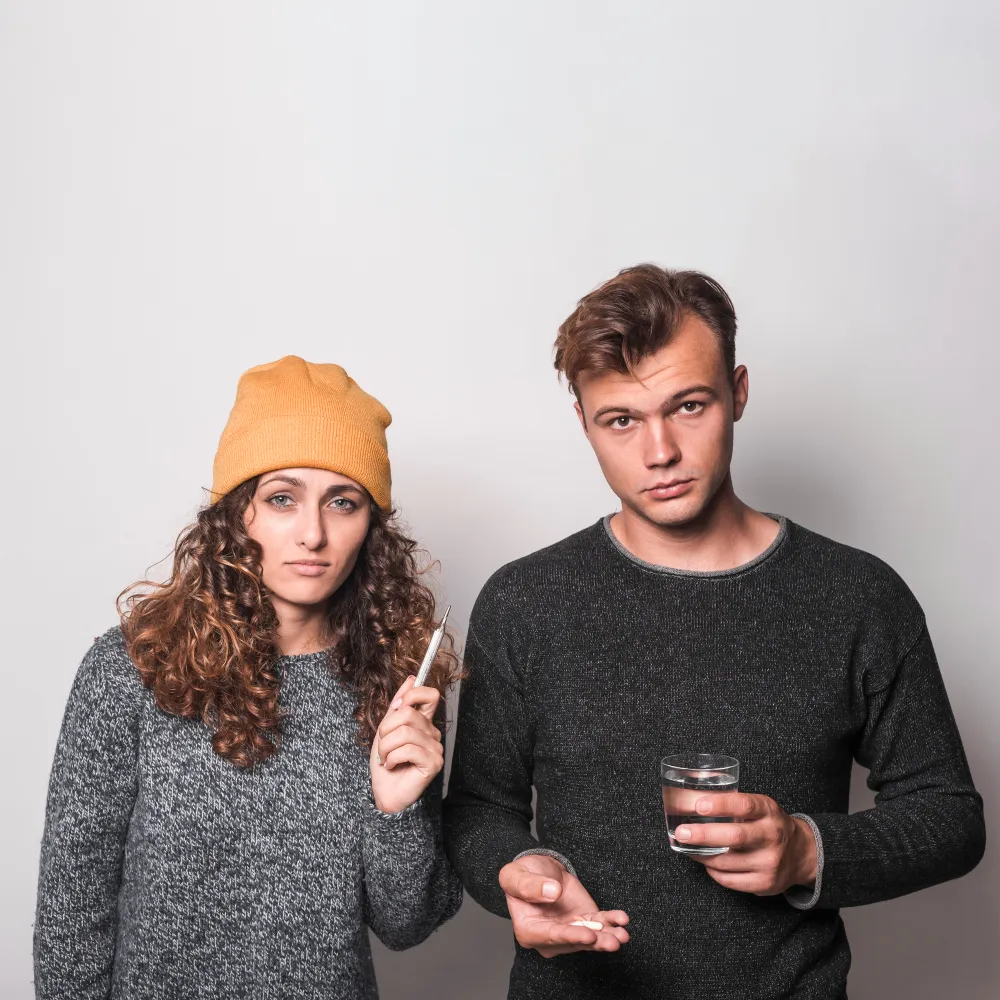Couple taking medication while addressing concerns related to STD Screening & Treatment Clinic services.